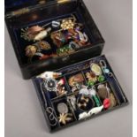 A black leather jewellery box with contents of costume jewellery. Includes Art Deco examples,