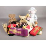 A box of assorted vintage dolls. To include a Pedigree golly, clockwork dog and two vicar's stoles