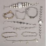 A collection of silver jewellery. Includes Accurist quartz bracelet watch and nine other bracelets.