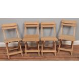 Four wooden folding child's chairs.