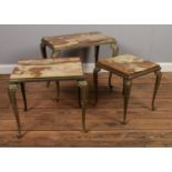 A nest of three gilt metal and onyx coffee tables. Largest: Height: 44cm, Width: 53cm, Depth: 34cm.