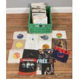 A box of vinyl rock single records, to include Rolling Stones, Queen, The Who, Bob Dylan and