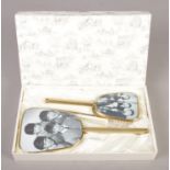 A 1960's Beatles vanity set; consisting of comb, clothes brush and mirror. In original box, mirror