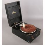 A Gerrard Chorister portable gramophone along with a quantity of 78 RPM records.