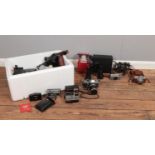 A box of assorted film cameras and equipment. To include a Polaroid 600 Land Camera, Praktica SLR