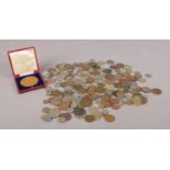 A large collection of UK and world coinage, together with Edward VII 1902 cased coronation medal.