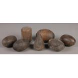 A collection of lignum vitae horse tether weights. 12cm to 14cm.