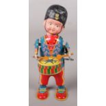 A tinplate clockwork drummer figurine. With key.