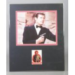 A mounted autograph display card of Roger Moore as James Bond. Signed. Height: 42cm, Width: 34cm.