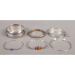 Six silver bangles. Includes amber set example.