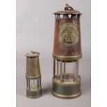 An Eccles Type SL miners safety lamp, together with a miniature example. Slight rust to Eccles