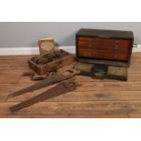A wooden apprentice tool chest with vintage tools. To include saws, hand drills and wind-up tape