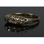 An 18ct gold five stone diamond ring. Size O. 2.88g.