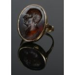 An 18ct gold intaglio ring, portrait of a gent, signed Hecker. Size T. 6.56g. Size of panel 2.3cm