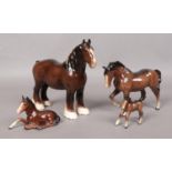 Four Beswick horses, including shire horse, kneeling chestnut (913) and foal. Shire horse 21.5cm