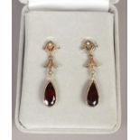 A pair of 9ct gold garnet and seed pearl drop earrings.