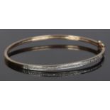 A 9ct Gold hinged bangle set with a band of small diamonds. Stamped 375 to inside of bangle. Total