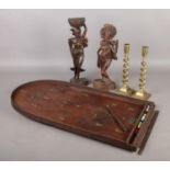 A Bagatelle, a pair of brass candlesticks and pair of carved Bali figures. Bagatelle comes with