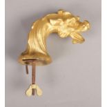 A gilt metal dragon head on screw, possibly a clock finnial or car mascot. 8cm high (excluding