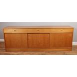 A large Danish made Teak sideboard. With three drawers over triple sliding doors. H: 71cm, W:200cm,