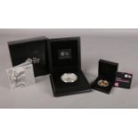 A Royal Mint Silver Proof 5oz coin and a Gold plated £5 Silver proof coin commemorating 'The