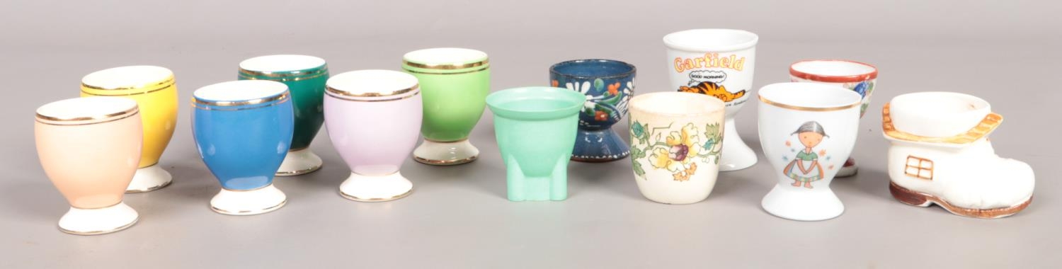 A quantity of egg cups; to include Masons and green bakelite example.
