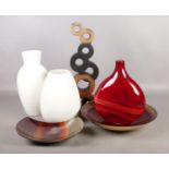 An assortment of ornaments. To include a John Rocha cream vase, a wooden sculpture and red glass