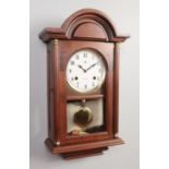 A mahogany cased wall clock. Dial stamped RR. Winder present. 62cm high.