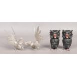 A pair of white metal cockerels, together with a pair of owl candlestick holders. Damage to owl