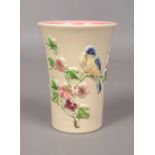 A Newport Pottery Clarice Cliff small vase, depicting a blue tit perched on flowers. 13cm high.