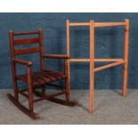 A stained pine child's rocking chair, together with a child's clothes airer.