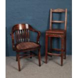 Two wooden chairs. To include an early 20th century ash Clerks chair and a mahogany office chair