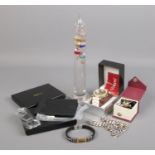 A box of collectables. Includes Galileo thermometer, FlinTronic wallet and money clip sets,