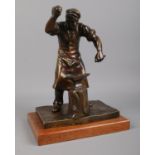 A Bronze figure depicting a Blacksmith on wooden plinth. H: 25cm Signed to the base, but
