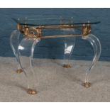 A ornate glass topped coffee table. (52cm height 60cm width 63cm depth)