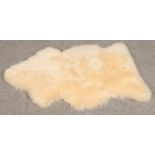 A Bowron gold star sheepskin rug, 110cm x 80cm.