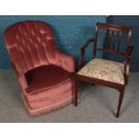 A deep buttoned upholstered bedroom chair along with a mahogany armchair.