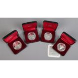 Four cased Canadian silver dollars. Includes two marking the 100th anniversary of The National Parks