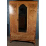 A walnut three piece bedroom suite. Comprising of mirror front wardrobe, dressing table and chest of