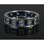 A 9ct white gold eternity ring set with blue and clear stones. Size R. 4.6g.