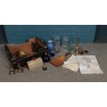 A box of miscellaneous. To include glassware, linen napkins, and a brass table lamp etc.