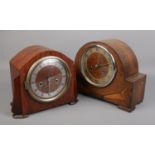 Two eight day mantel clocks. One oak, the other mahogany.