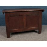 An early 20th Century oak panelled coffer with hinged lid. H: 53cm, W:82cm D: 43cm.