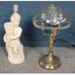 A cut glass and brass table lamp along with a figural plaster example.
