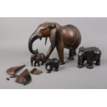 Three carved Ebony & hardwood Elephants. Tallest: H: 22.5cm. Damage to ears of larger elephant,