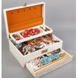 A jewellery box with contents. Including beads, necklaces, earrings, cuff links, etc.