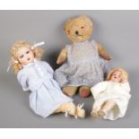 A vintage teddy bear, together with two dolls including Armand Marseille 996 example.