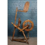 A vintage wooden spinning wheel.