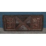 A large carved hardwood African plaque. H:37.5cm W:90cm.