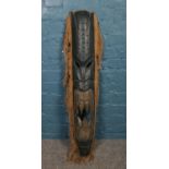 A large carved tribal wall mask. H: 101cm.